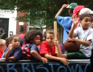 Children waving to parade-goers...