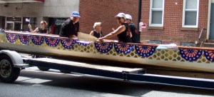 A dragon boat coming down the street